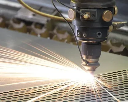 A CNC laser cutting machine cutting through a metal sheet with precision.