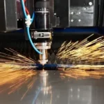 A Co2 laser cutting machine cutting through a sheet of acrylic with precision at https://laserwaterjetindia.com/